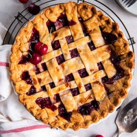 Whole baked cherry pie with lattice crust.
